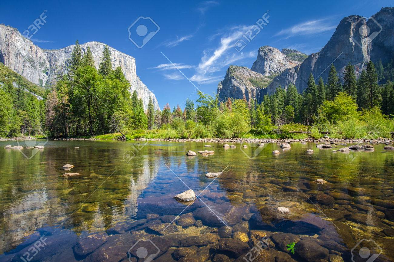 Classic view of scenic Yosemite Valley with famous El Capitan rock climbing summit and idyllic Merced river on a sunny day with blue sky and clouds in summer, Yosemite National Park, California, USA - 76486050 Classic view of scenic Yosemite Valley with famous El Capitan rock climbing summit and idyllic Merced river on a sunny day with blue sky and clouds in summer, Yosemite National Park, California, USA - 76486050