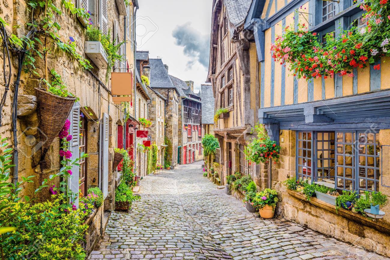 Beautiful view of scenic narrow alley with historic traditional houses and cobbled street in an old town in Europe with blue sky and clouds in summer with retro vintage grunge filter effect - 76421860 Beautiful view of scenic narrow alley with historic traditional houses and cobbled street in an old town in Europe with blue sky and clouds in summer with retro vintage grunge filter effect - 76421860