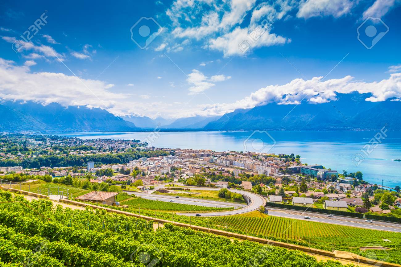 Aerial panoramic view of the city of Vevey at Lake Geneva with vineyards of famous Lavaux wine region on a beautiful sunny day with blue sky and clouds in summer, Canton of Vaud, Switzerland - 94981641 Aerial panoramic view of the city of Vevey at Lake Geneva with vineyards of famous Lavaux wine region on a beautiful sunny day with blue sky and clouds in summer, Canton of Vaud, Switzerland - 94981641