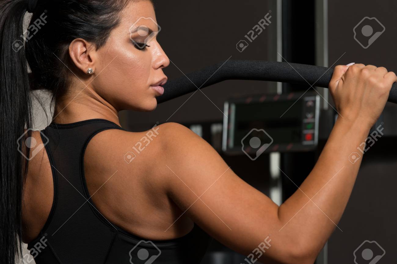 Sexy Latino Woman Working Out Back On Machine In Fitness Center Stock Photo 50219427 Sexy Latino Woman Working Out Back On Machine In Fitness Center Stock Photo 50219427