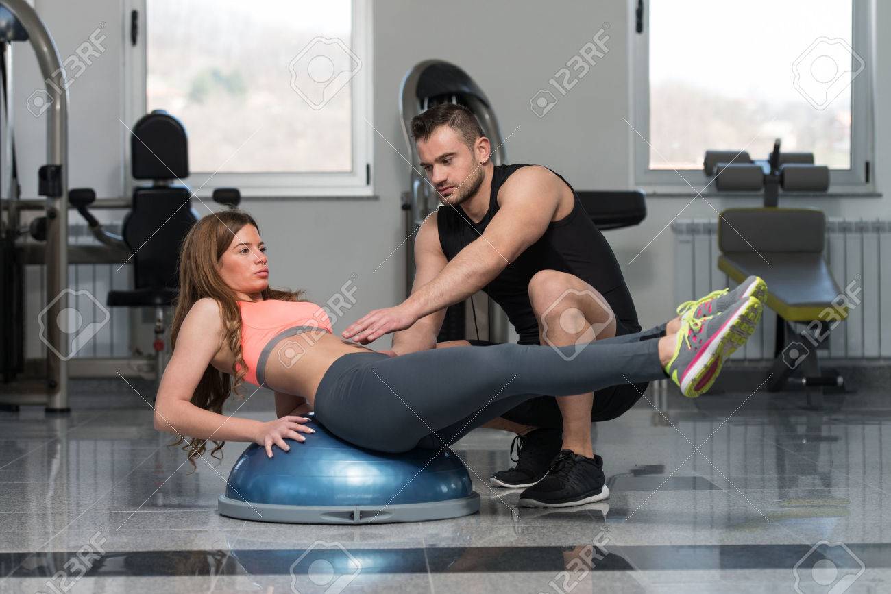 Personal Trainer Showing Young Woman How To Train On Bosu Abs Stock Photo Picture And Royalty Free Image Image 58662454