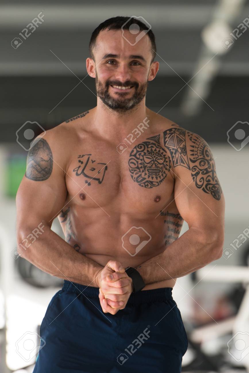 Healthy Young Tattoo Man Standing Strong In The Gym And Flexing Muscles -  Muscular Athletic Bodybuilder Fitness Model Posing After Exercises Stock  Photo, Picture and Royalty Free Image. Image 92718156., image size:867x1300