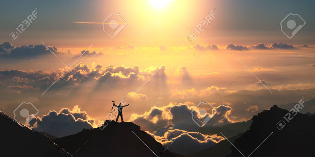 A man standing on the top of the mountain above the clouds. - 41903207 A man standing on the top of the mountain above the clouds. - 41903207