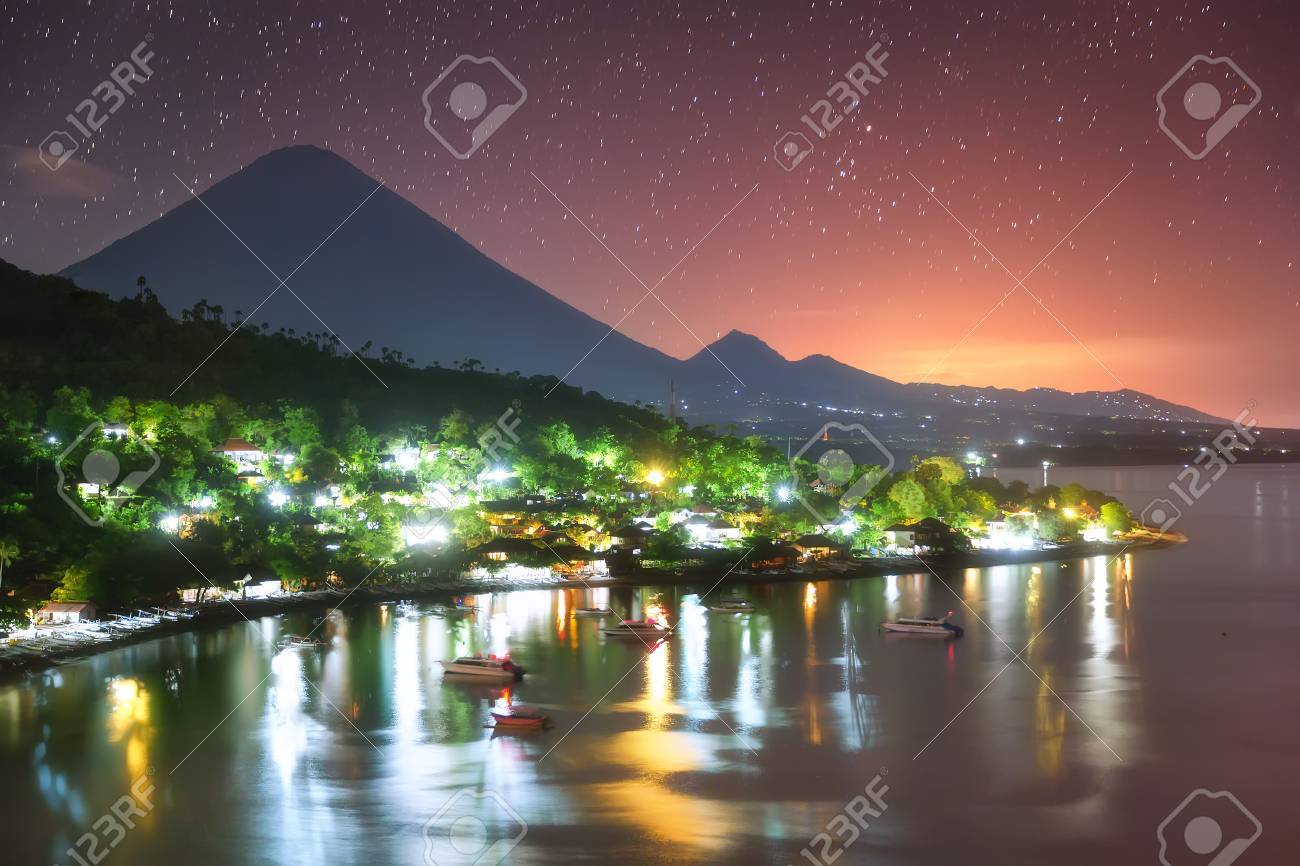 Colorful Amed harbor in the night and the highest point of the island, Agung volcano (3,142 m) is visible on the background. - 64930481 Colorful Amed harbor in the night and the highest point of the island, Agung volcano (3,142 m) is visible on the background. - 64930481
