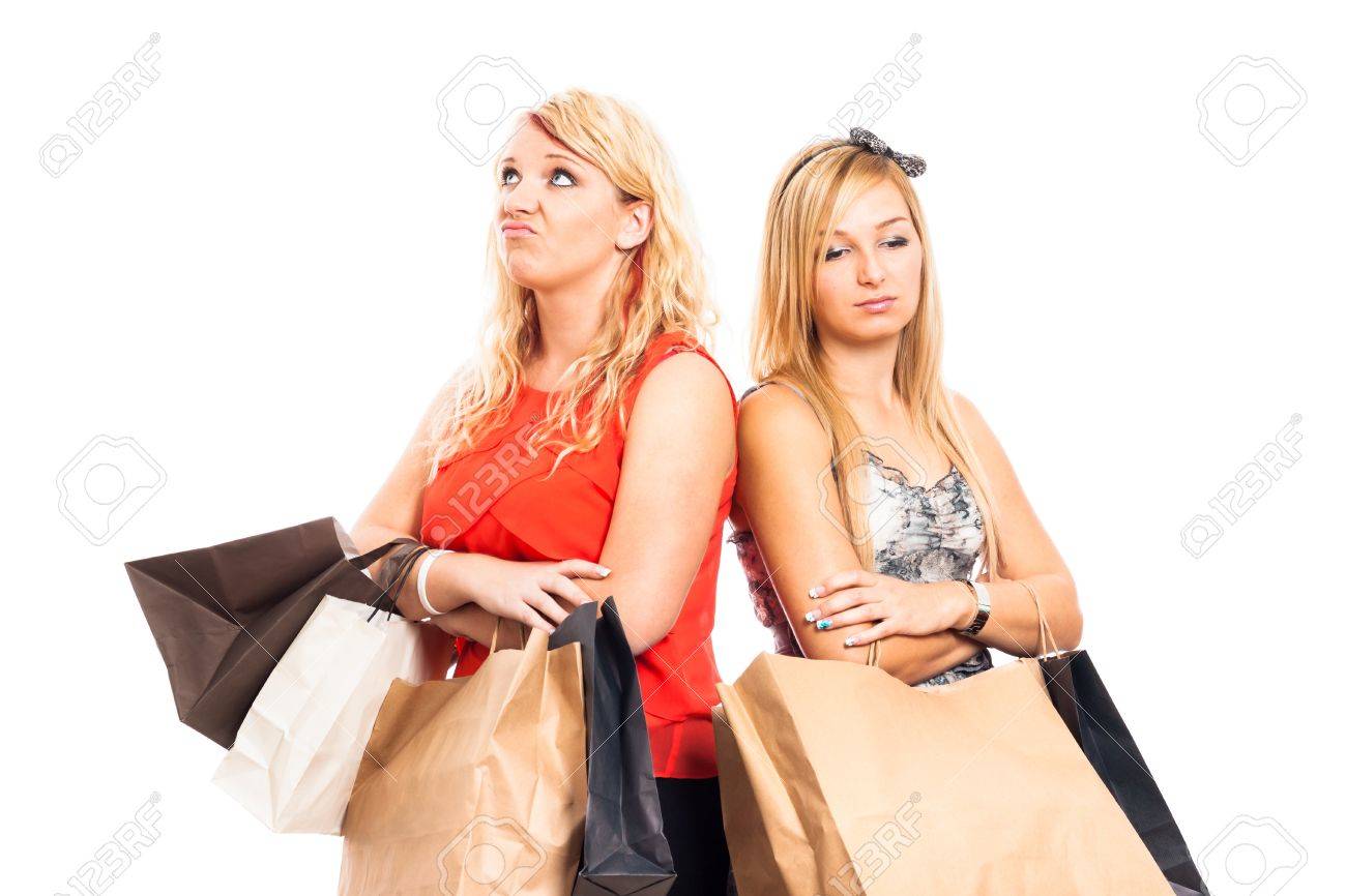 Two young blond unhappy women holding shopping bags, isolated on white background - 16120479 Two young blond unhappy women holding shopping bags, isolated on white background - 16120479