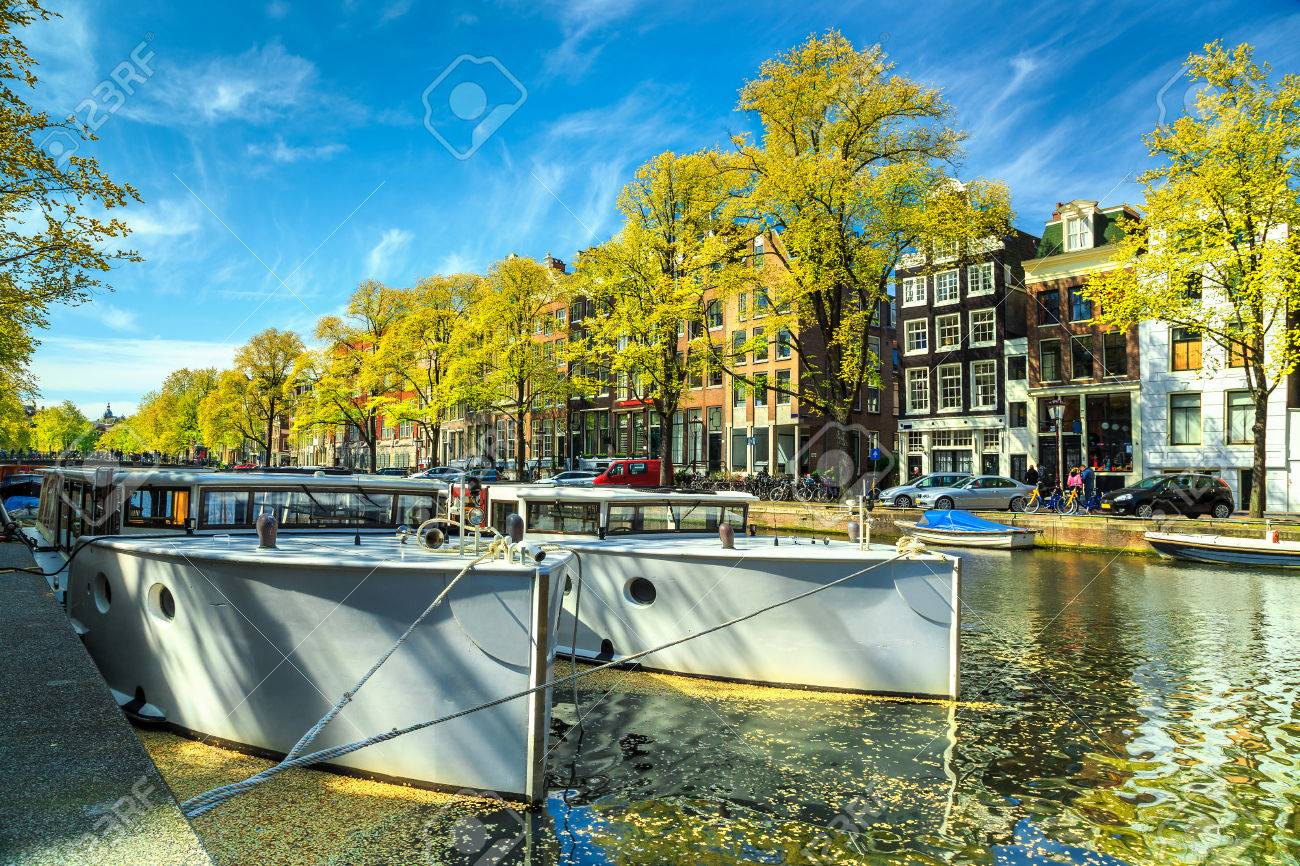 有名なアムステルダムの運河ボートと典型的なオランダのオランダ ヨーロッパの首都の家します の写真素材 画像素材 Image