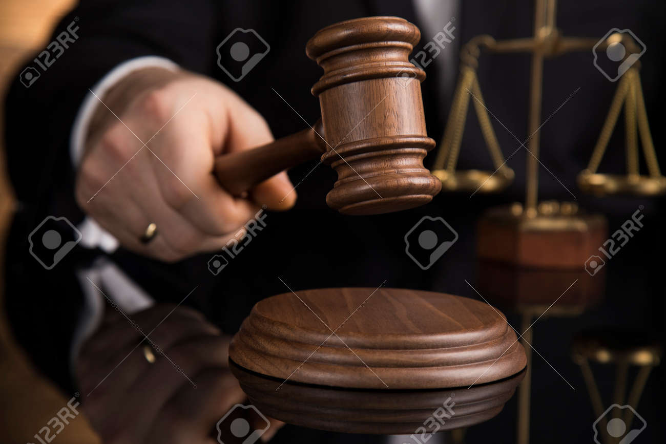 Judge, male judge in a courtroom striking the gavel - 134601665 Judge, male judge in a courtroom striking the gavel - 134601665