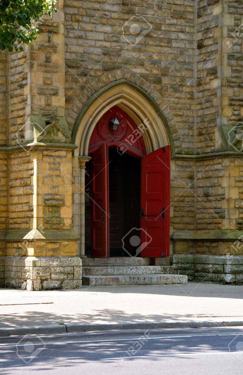 Open Church Doors a set of open red church doors against old brick wall. stock photo Open Church Doors a set of open red church doors against old brick wall. stock photo