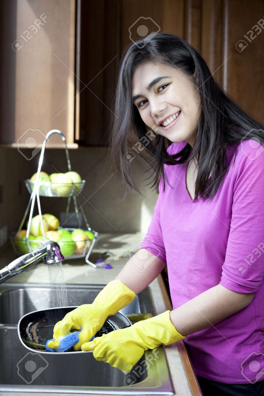 Kitchen Sink With Clean Dishes teen girl happily washing dishes at kitchen sink stock photo Kitchen Sink With Clean Dishes teen girl happily washing dishes at kitchen sink stock photo