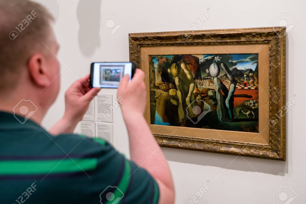 london united kingdom may 12 man looking at salvador dali salvador dali painting