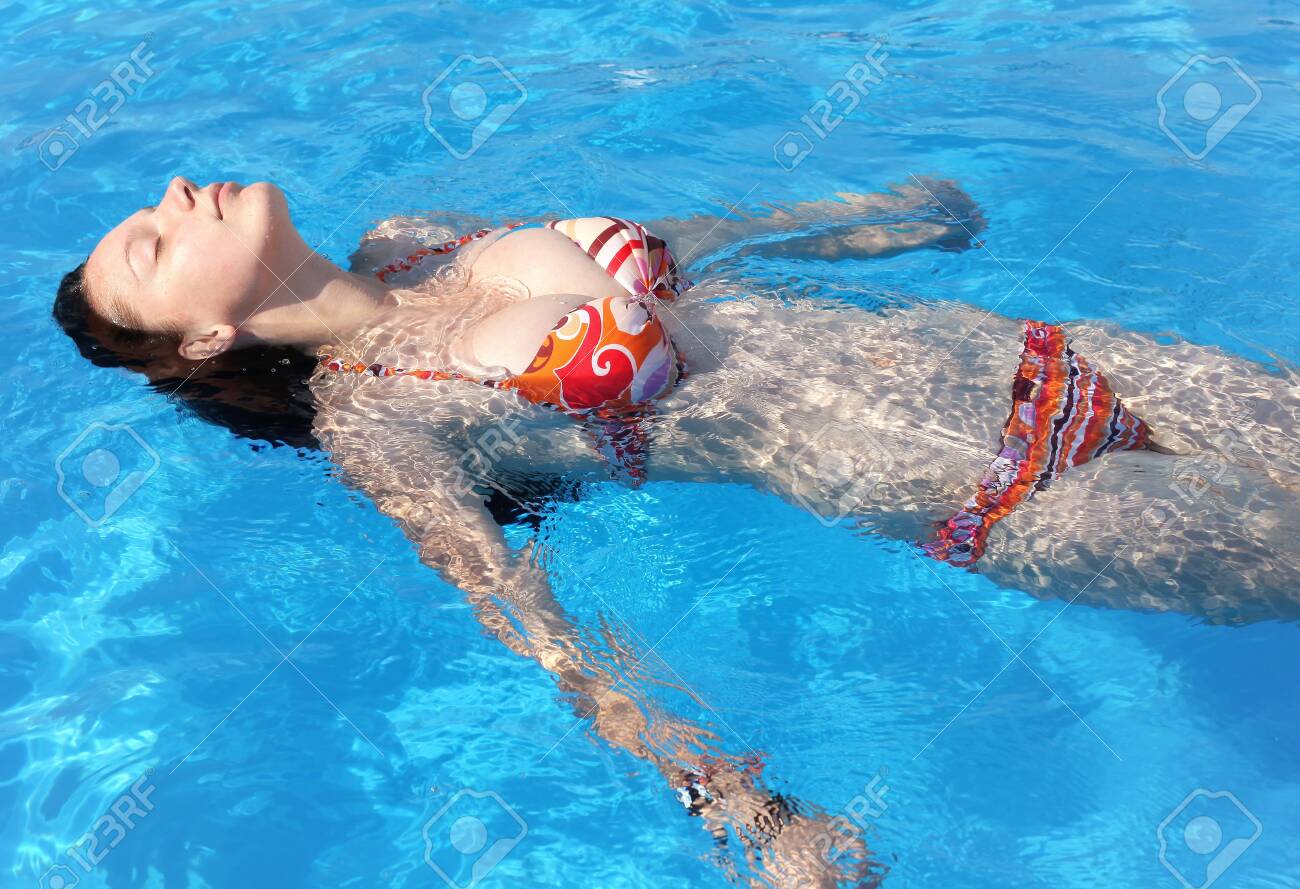 Girl With Perfect Body And Big Boobs Relaxing In The Pool Stock Photo,  Picture and Royalty Free Image. Image 134834977.