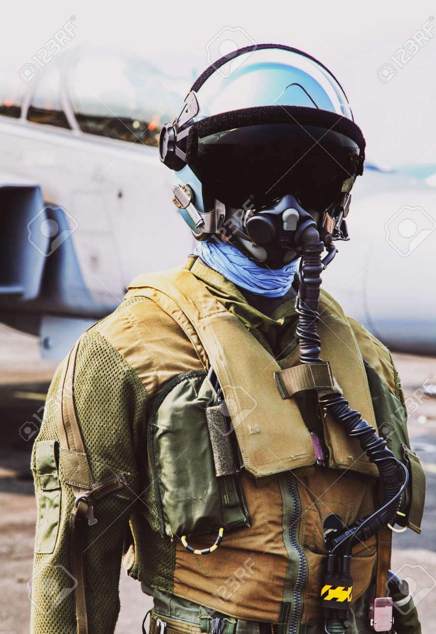 FIghter Pilot In Helmet And Suit With Oxygen Mask In Front Of