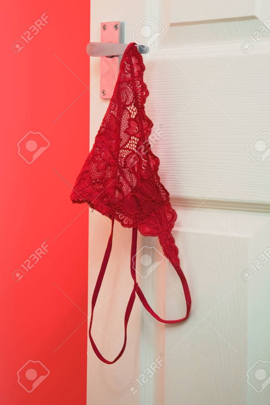 Red Sexy Knickers Hanging Off A Bedroom 