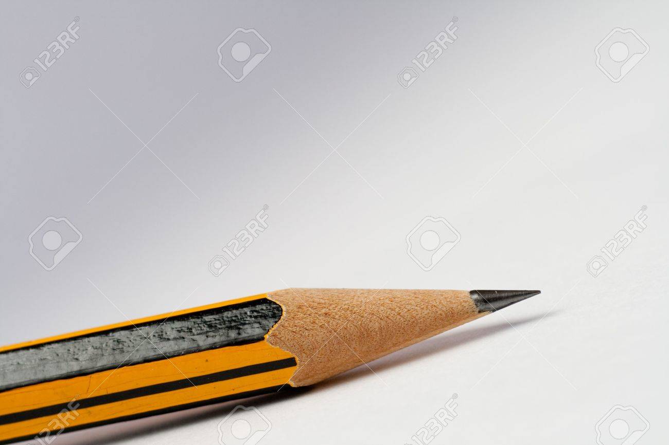 a sharp pencil on white gray background background fades from fades of gray