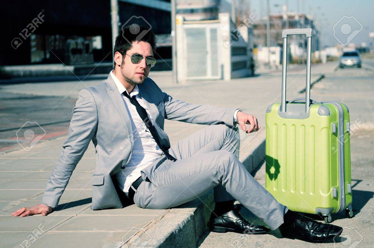Man Dressed In Suit And Suitcase Sitting On The Floor In The Street Stock Photo Picture And Royalty Free Image Image