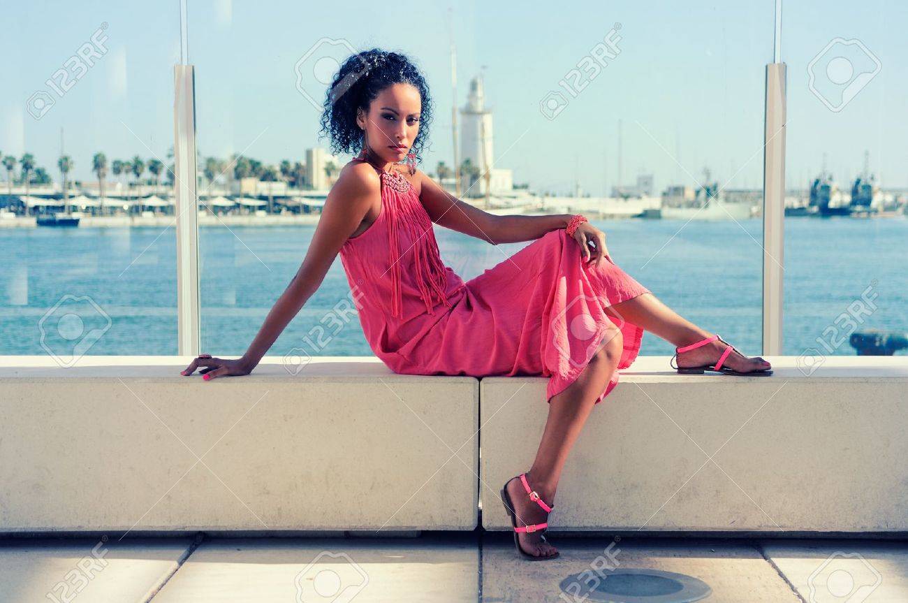 若い黒人女性で アフロのヘアスタイル 港に長いピンクのドレスを着ての肖像画 の写真素材 画像素材 Image