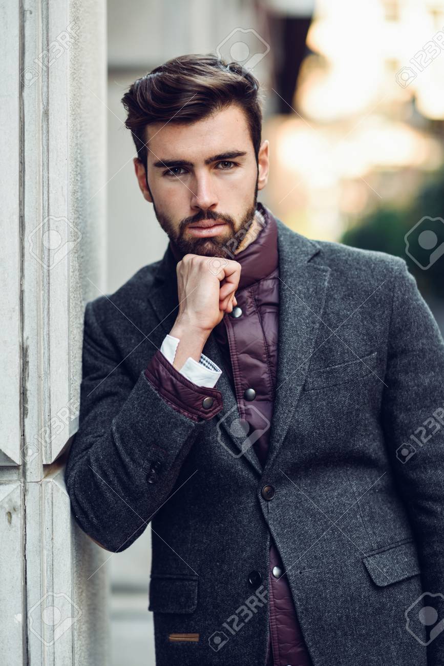 Young Bearded Man, Model Of Fashion, In Urban Background Wearing British Elegant Suit. Guy With Beard And Modern Hairstyle In The Street. Stock Photo, Picture And Royalty Free Image. Image 105330395. Young Bearded Man, Model Of Fashion, In Urban Background Wearing British Elegant Suit. Guy With Beard And Modern Hairstyle In The Street. Stock Photo, Picture And Royalty Free Image. Image 105330395.
