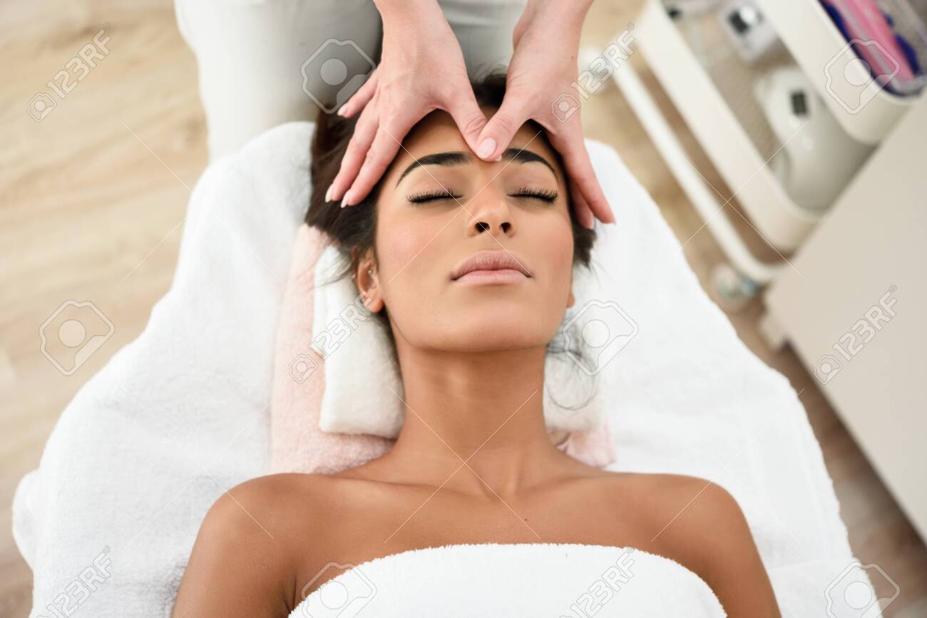 Woman receiving head massage in spa wellness center. - 122010063 Woman receiving head massage in spa wellness center. - 122010063