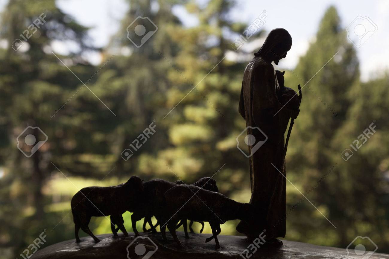 Sculpture of Jesus Christ with flock of lambs on backlight - 38187540 Sculpture of Jesus Christ with flock of lambs on backlight - 38187540