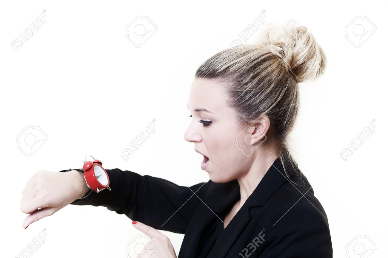 woman in a suit looking at a wrist watch made to look like a stock