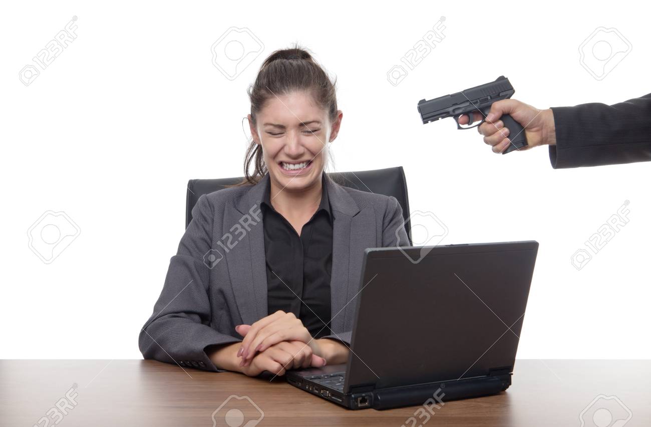 87336152-business-woman-sitting-at-her-desk-with-a-gun-to-her-head.jpg