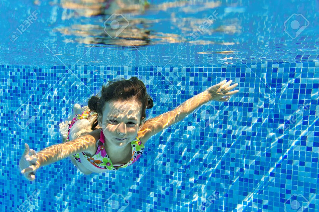Happy active child swims underwater in pool, beautiful healthy girl swimming and having fun on family summer vacation, kids sport concept - 21976315 Happy active child swims underwater in pool, beautiful healthy girl swimming and having fun on family summer vacation, kids sport concept - 21976315
