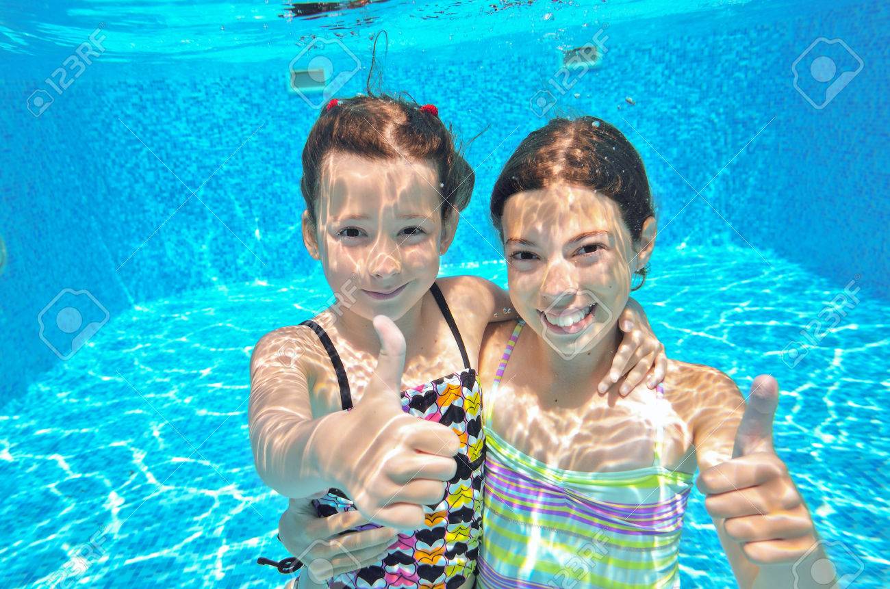 happy active kids swim in pool and play underwater girls diving and having fun - Kids Swimming Underwater happy active kids swim in pool and play underwater girls diving and having fun - Kids Swimming Underwater
