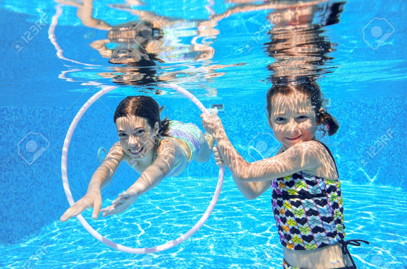 Happy active kids swim in pool and play underwater, girls diving and having fun, children on summer vacation, sport concept - 30533080 Happy active kids swim in pool and play underwater, girls diving and having fun, children on summer vacation, sport concept - 30533080