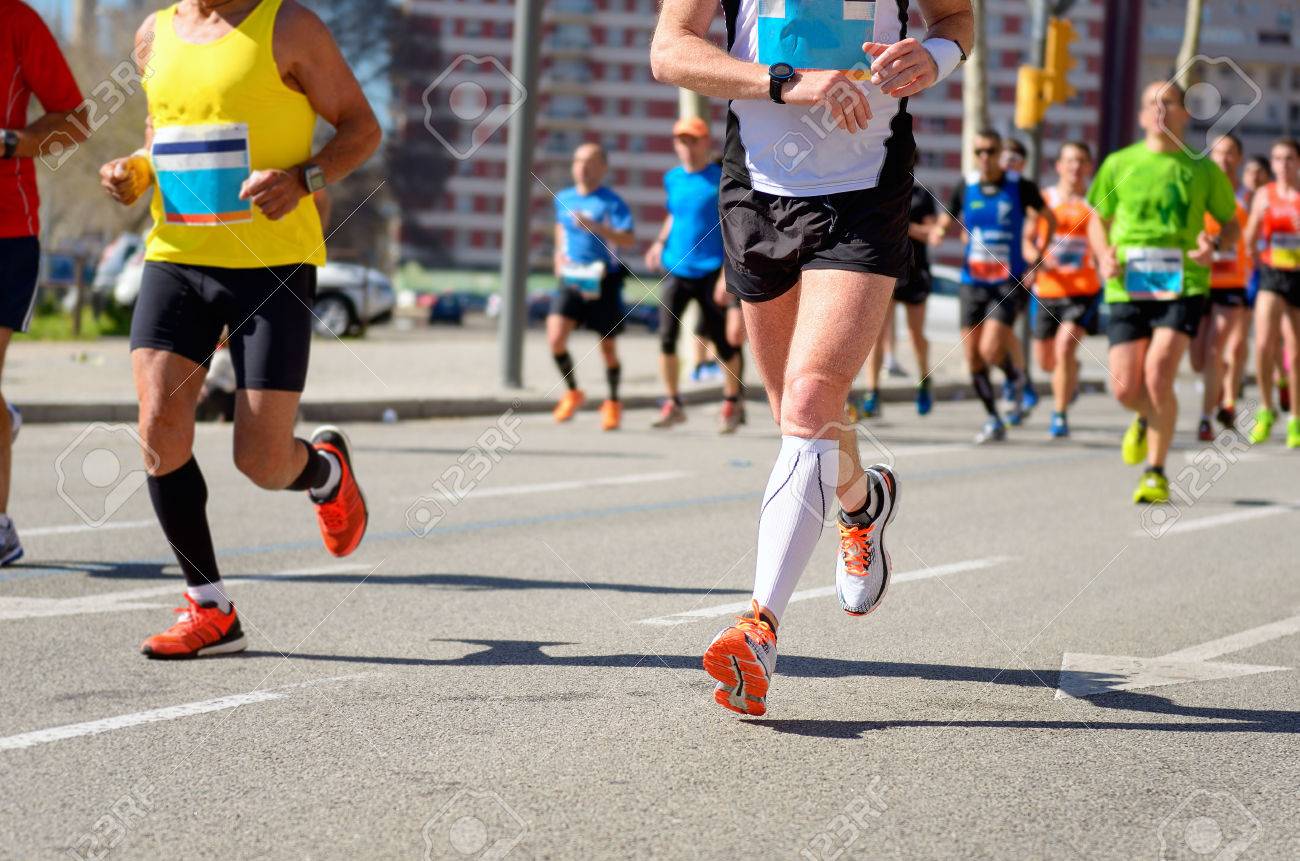 Marathon running race, runners feet on road, sport, fitness and healthy lifestyle concept - 38986265 Marathon running race, runners feet on road, sport, fitness and healthy lifestyle concept - 38986265