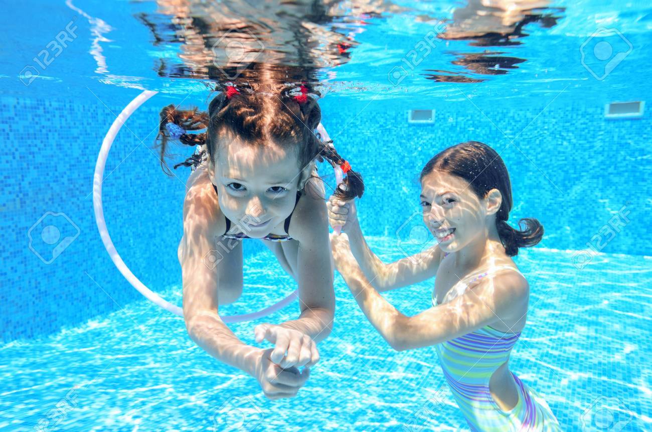 Happy children swim in pool underwater, girls swimming, playing and having fun, kids water sport - 42906785 Happy children swim in pool underwater, girls swimming, playing and having fun, kids water sport - 42906785