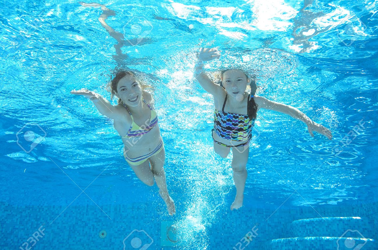 Children swim in pool underwater, happy active girls have fun in water, kids sport on family vacation - 43392601 Children swim in pool underwater, happy active girls have fun in water, kids sport on family vacation - 43392601