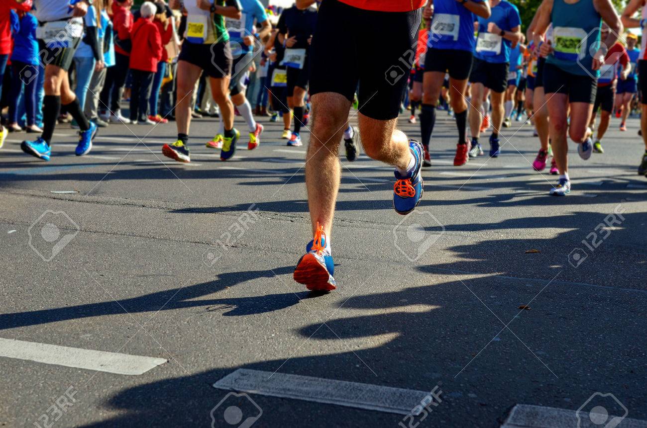 Marathon running race, runners feet on road, sport, fitness and healthy lifestyle concept - 50775959 Marathon running race, runners feet on road, sport, fitness and healthy lifestyle concept - 50775959