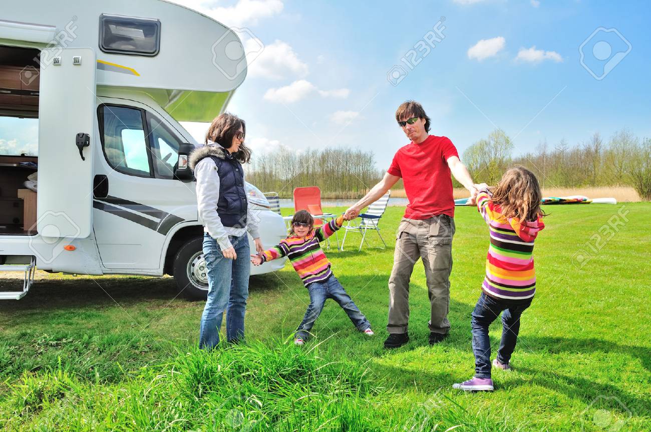 Family vacation, RV (camper) travel with kids, happy parents with children on holiday trip in motorhome - 71160136 Family vacation, RV (camper) travel with kids, happy parents with children on holiday trip in motorhome - 71160136