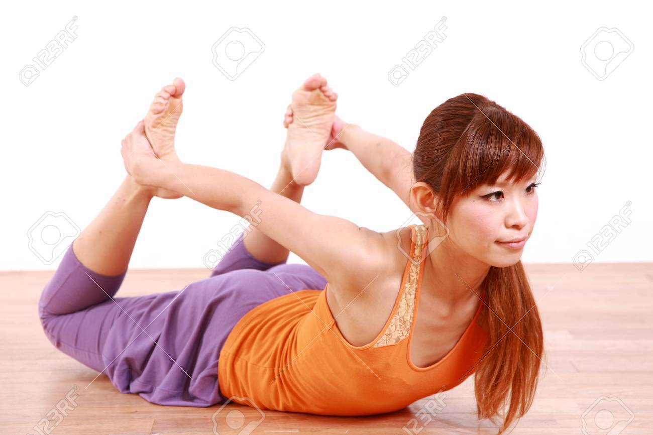 Young Japanese Woman Doing YOGA frog pose Young Japanese Woman Doing YOGA frog pose