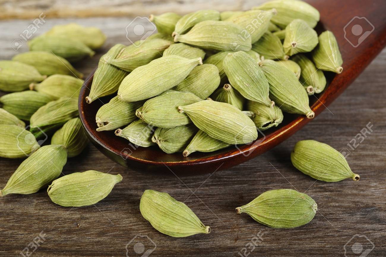 green cardamom pods in wooden spoon stock photo picture and royalty free image image 51066780 green cardamom pods in wooden spoon