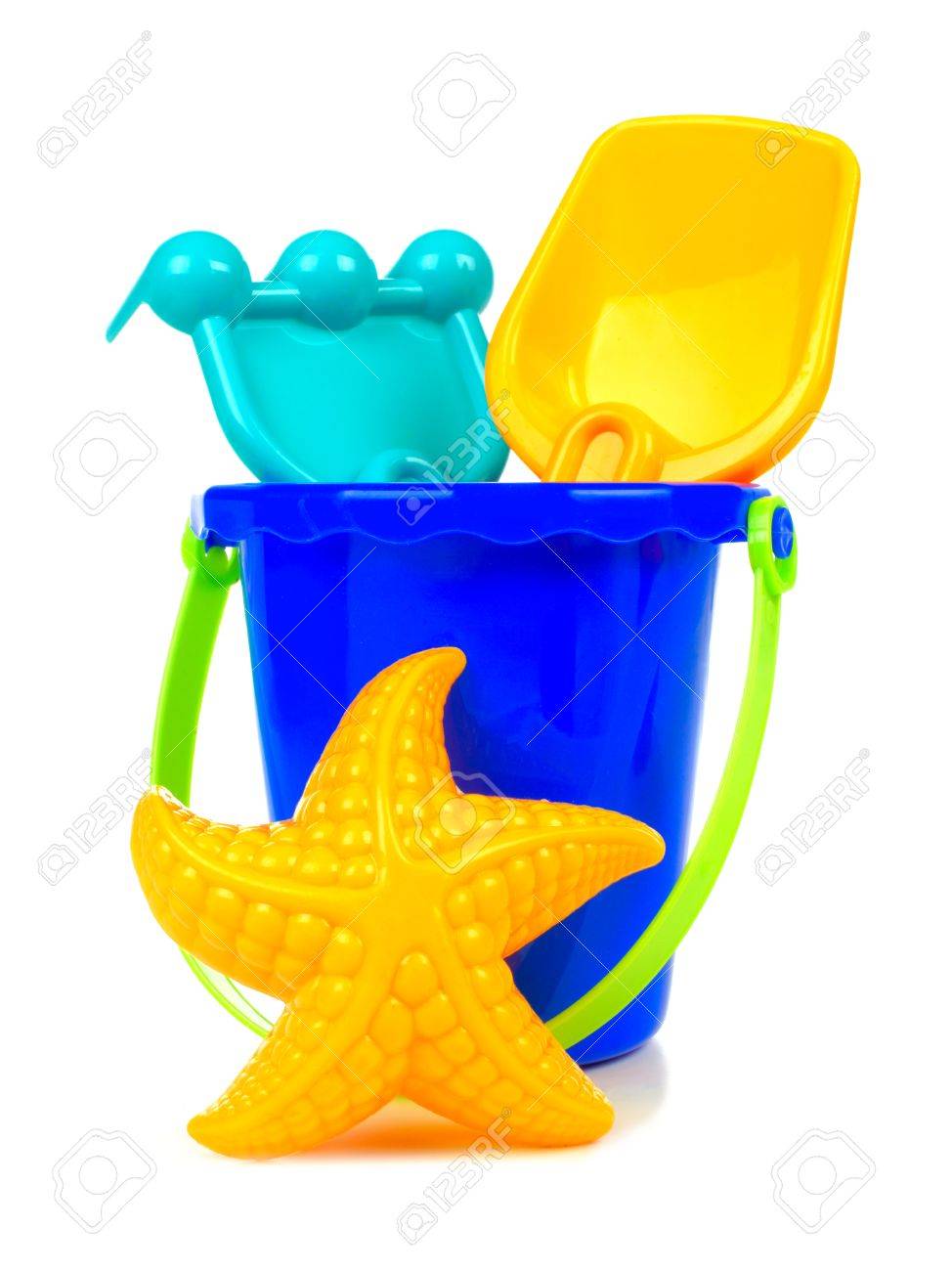 Uncategorized Toy Pail toy sand pail with rake shovel and starfish over a white background stock photo