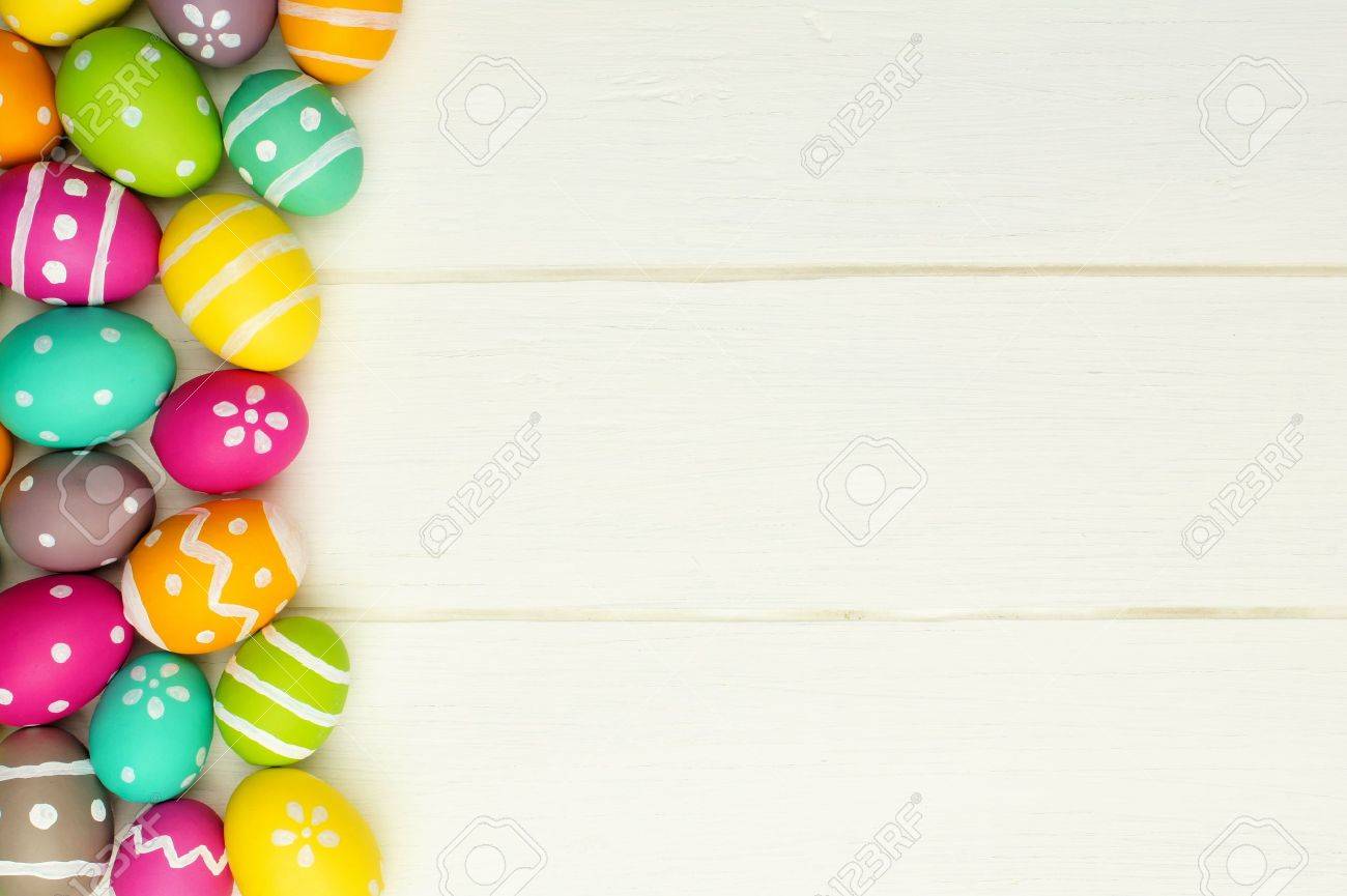 colorful easter egg side border against a white wood background easter egg background