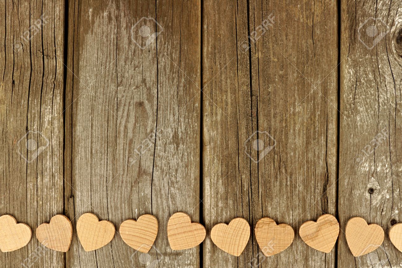 Valentines Day Wooden Hearts Forming A Bottom Border On Rustic Wood Background Stock Photo Valentines Day Wooden Hearts Forming A Bottom Border On Rustic Wood Background Stock Photo