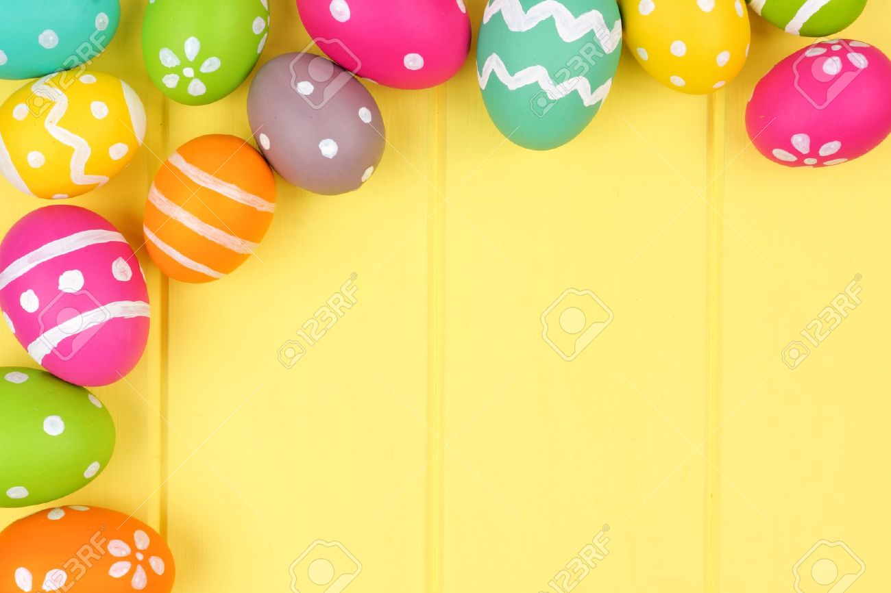 colorful easter egg corner border against a yellow wood background easter egg background