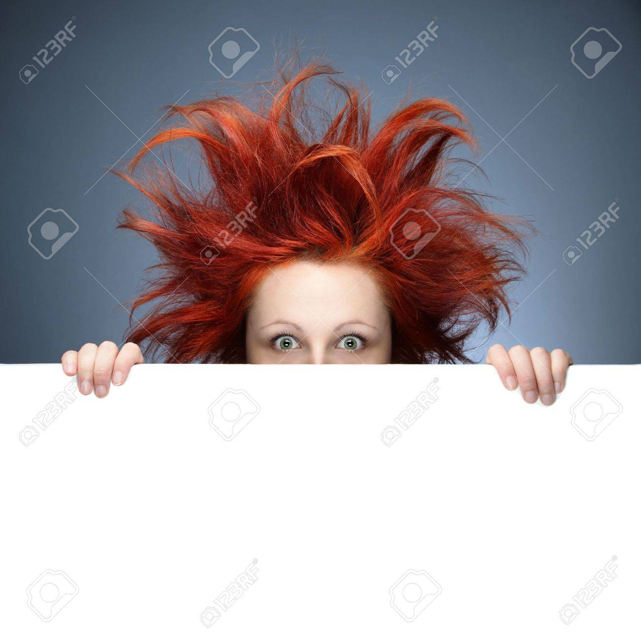 Redhead woman with messy hair against gray background - 11889953 Redhead woman with messy hair against gray background - 11889953