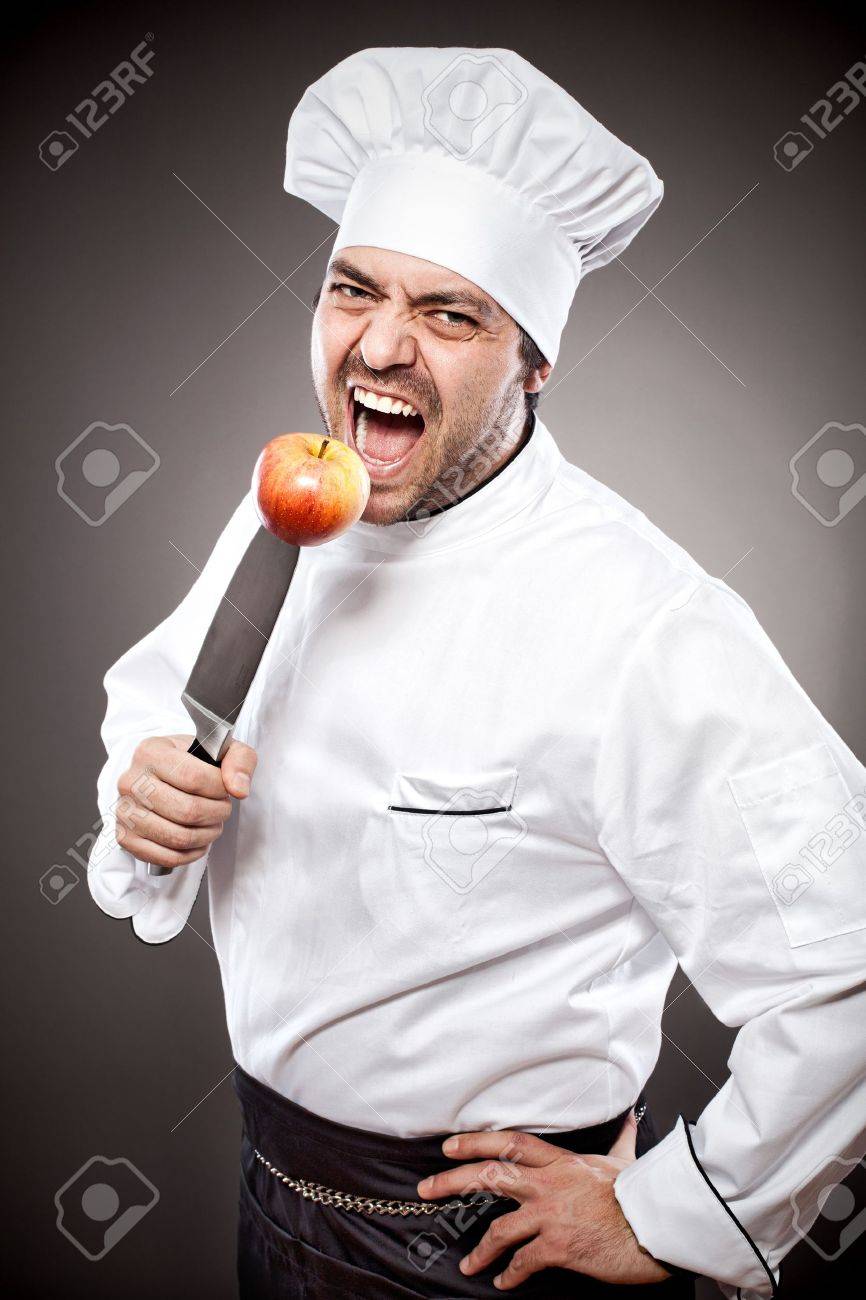 Chef with knife posing against gray background - 15985414 Chef with knife posing against gray background - 15985414