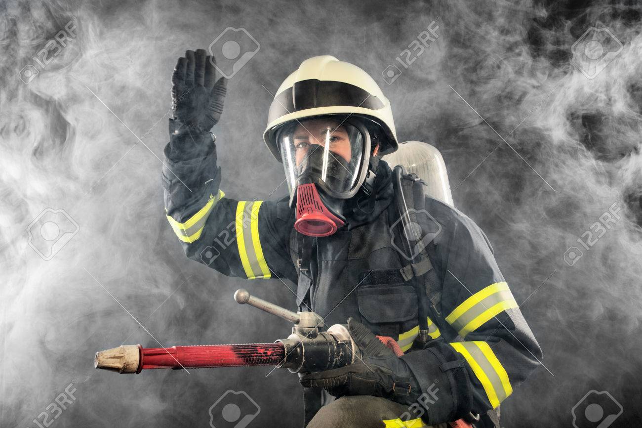 Firefighter giving directions in burning place - 25024984 Firefighter giving directions in burning place - 25024984