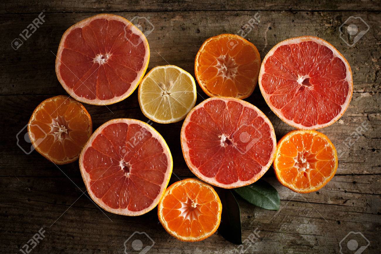 Different kind of citrus fruits on wooden board - 35972606 Different kind of citrus fruits on wooden board - 35972606