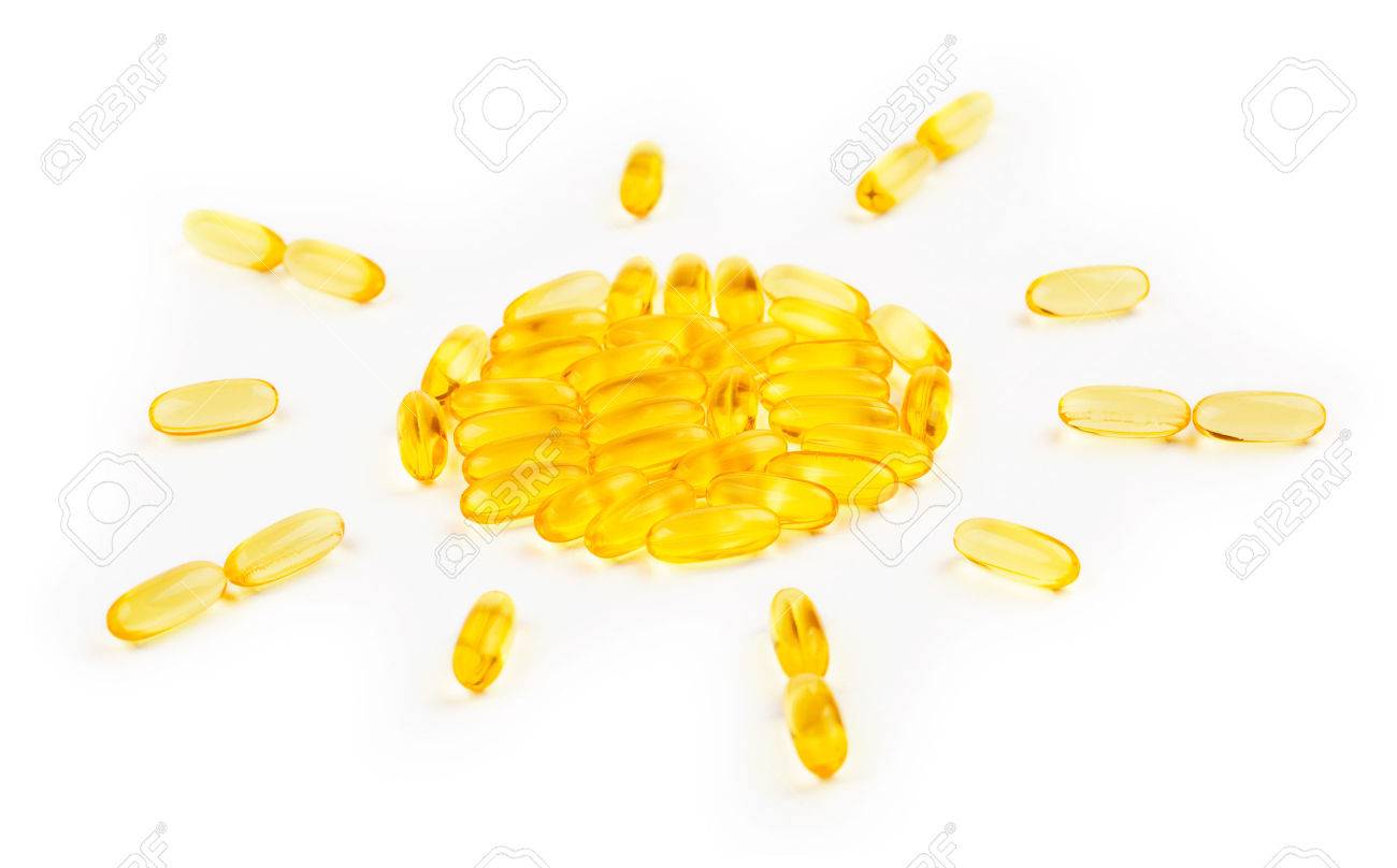 Vitamin D3 capsules shaped in sun symbol on white background - 70612472 Vitamin D3 capsules shaped in sun symbol on white background - 70612472