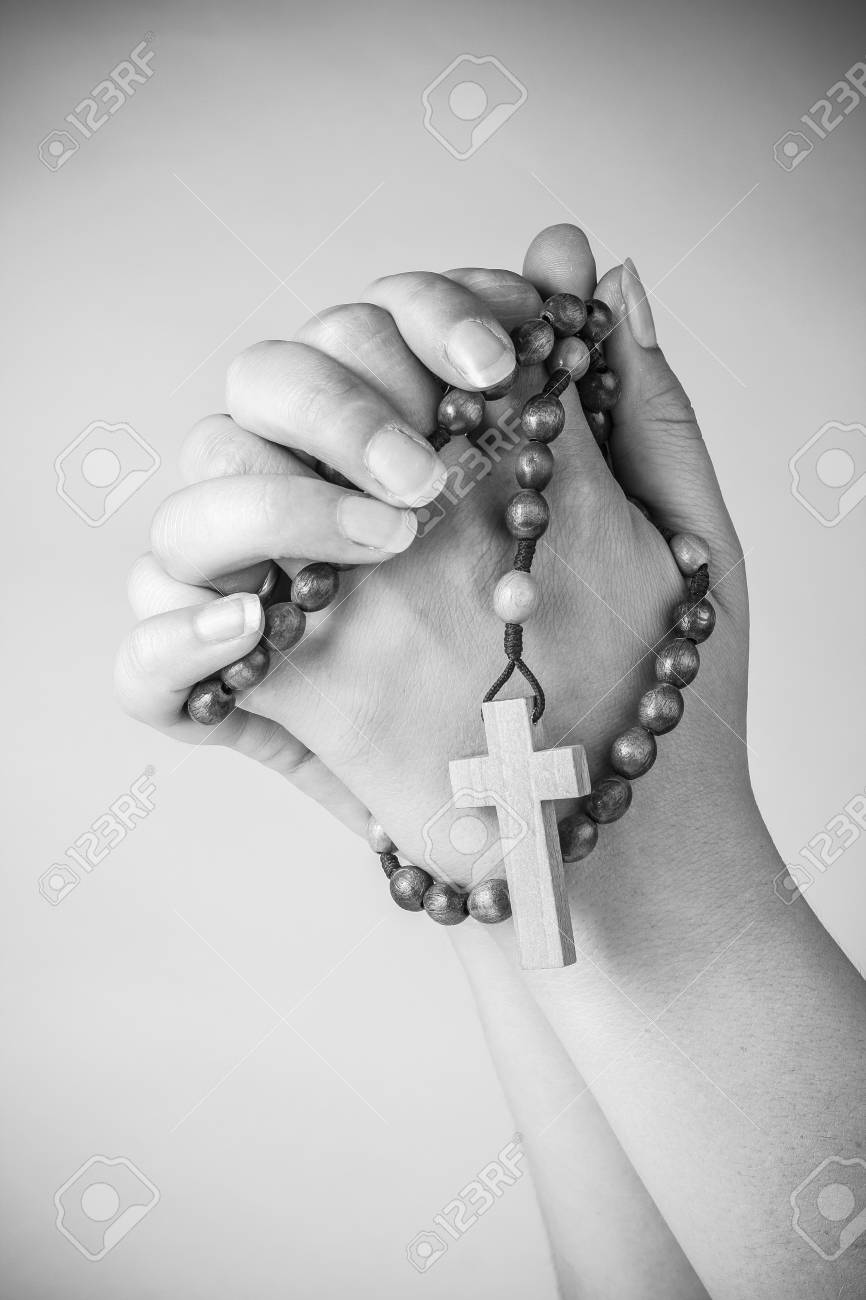 prayer hands with rosary