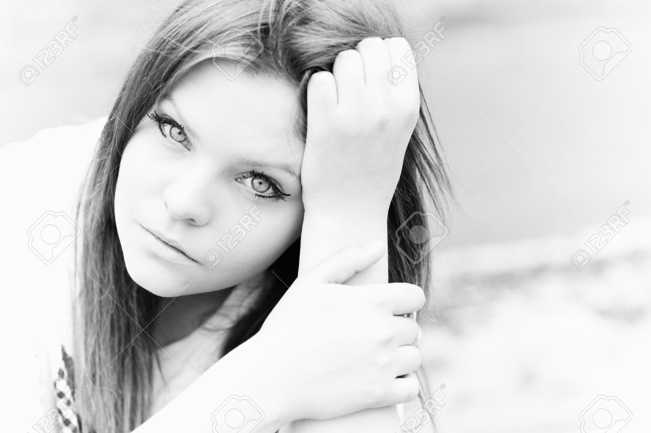 Closeup portrait of beautiful young girl in high key black and white photo stock photo