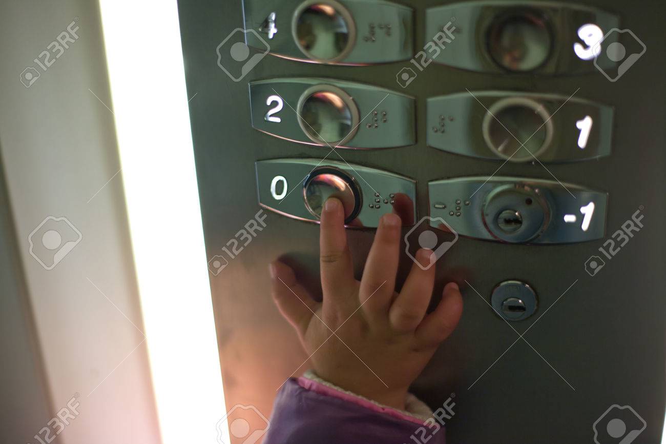 Hand Of A Toddler In Elevator Or Lift Pressing The Button To