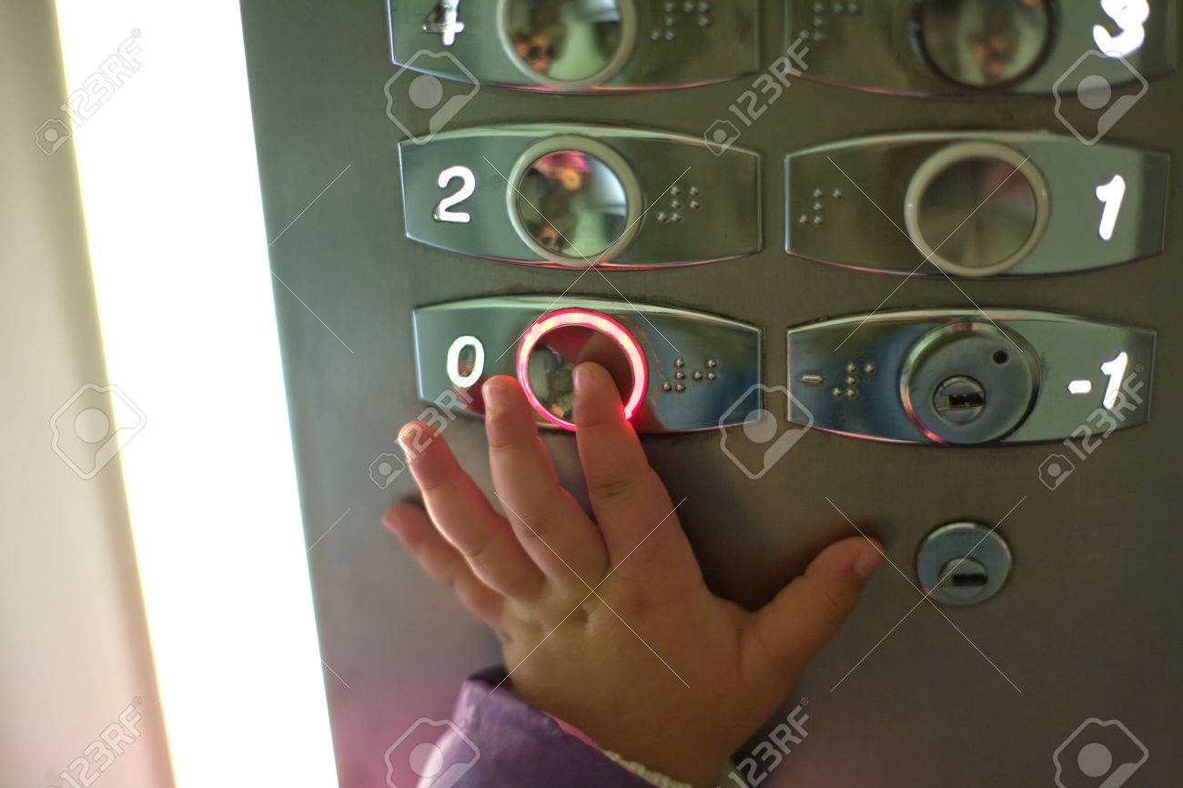 Hand Of A Toddler In Elevator Or Lift Pressing The Button To