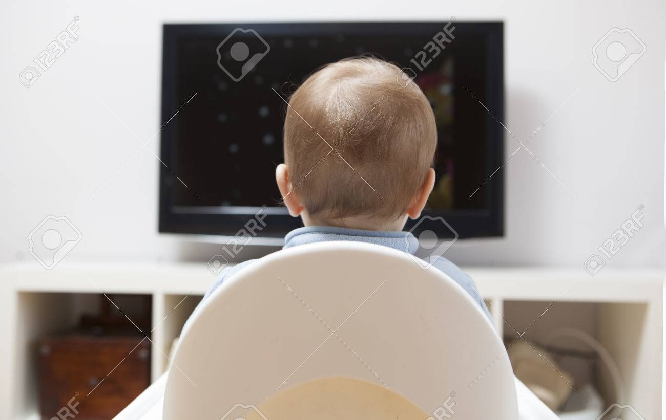 Baby Boy Watching Cartoons On Tv He Is Sitting On His Highchair Stock Photo Picture And Royalty Free Image Image 72063446