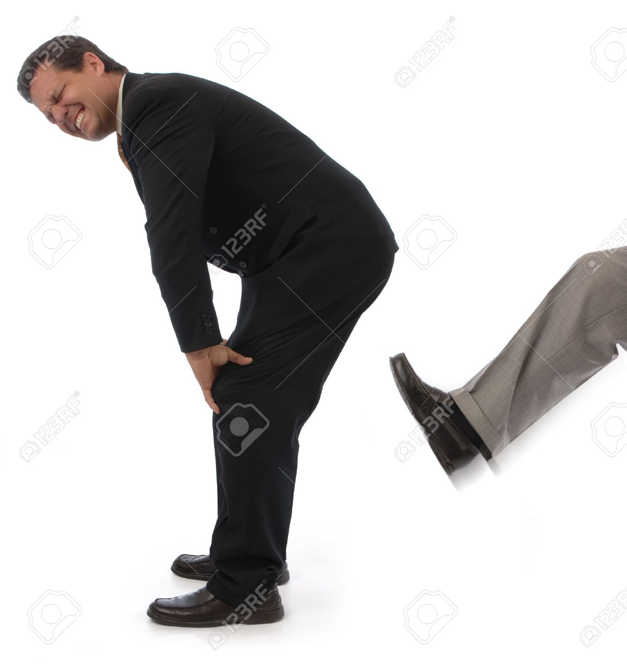 Man On A White Background Getting Kicked In The Behind Stock Photo, Picture and Royalty Free Image. Image 7039705.